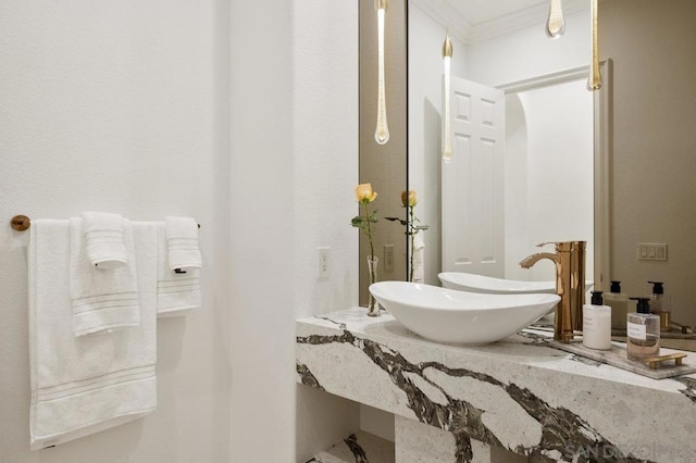 bathroom with sink and crown molding