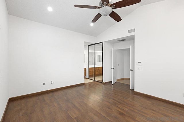 unfurnished bedroom with lofted ceiling, ceiling fan, dark wood-type flooring, and a closet