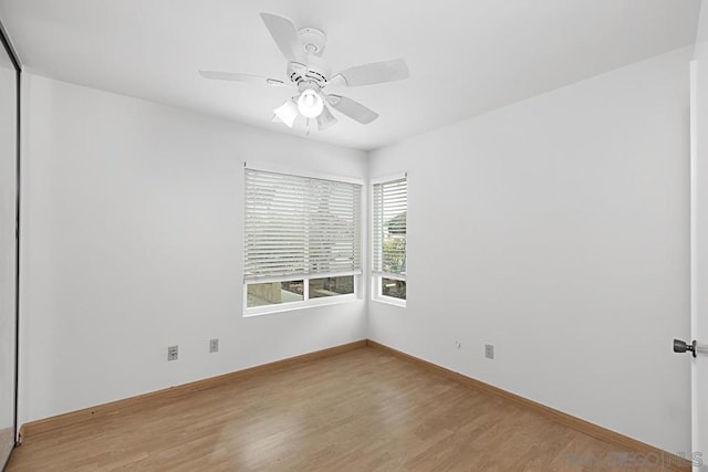 spare room featuring light wood-type flooring and ceiling fan