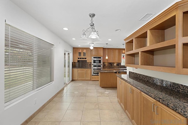 kitchen with pendant lighting, light tile patterned floors, double oven, and dark stone counters