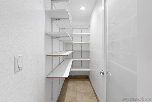 spacious closet featuring light tile patterned floors