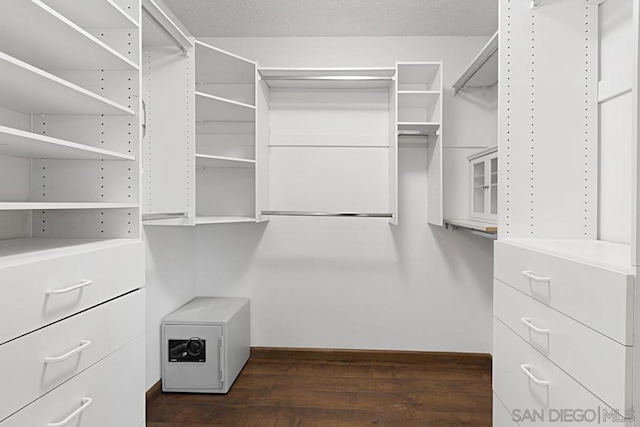 spacious closet with dark wood-type flooring