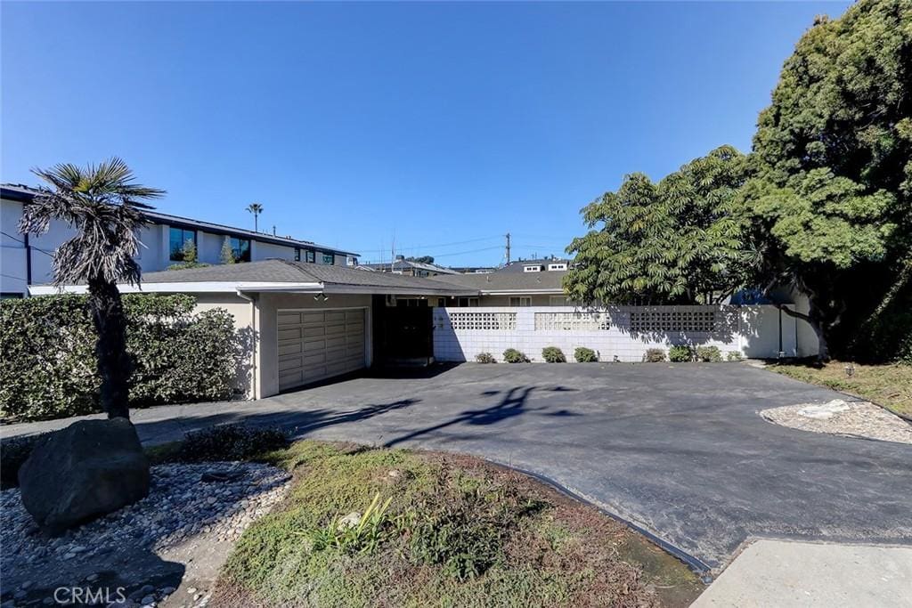 ranch-style house featuring a garage