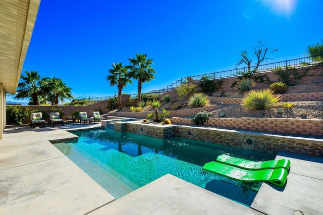 view of swimming pool with a patio area and an in ground hot tub