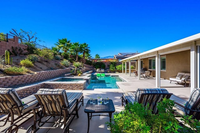 view of swimming pool with a patio area and an in ground hot tub