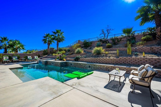 view of swimming pool featuring an in ground hot tub and a patio area