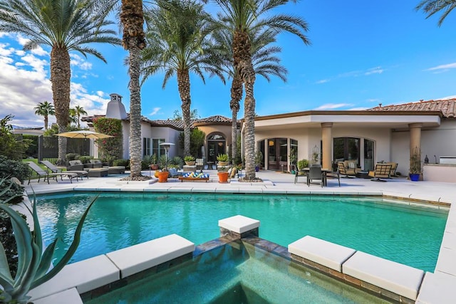 view of pool featuring an in ground hot tub and a patio area