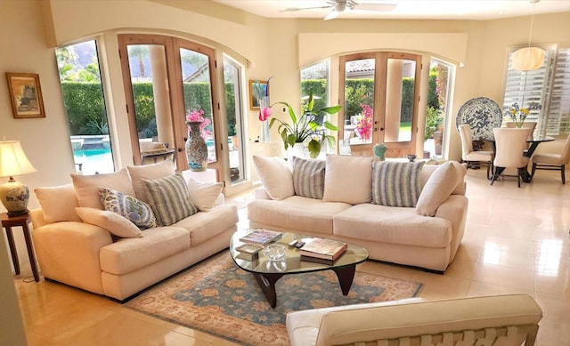 living room featuring french doors, plenty of natural light, and light tile patterned floors