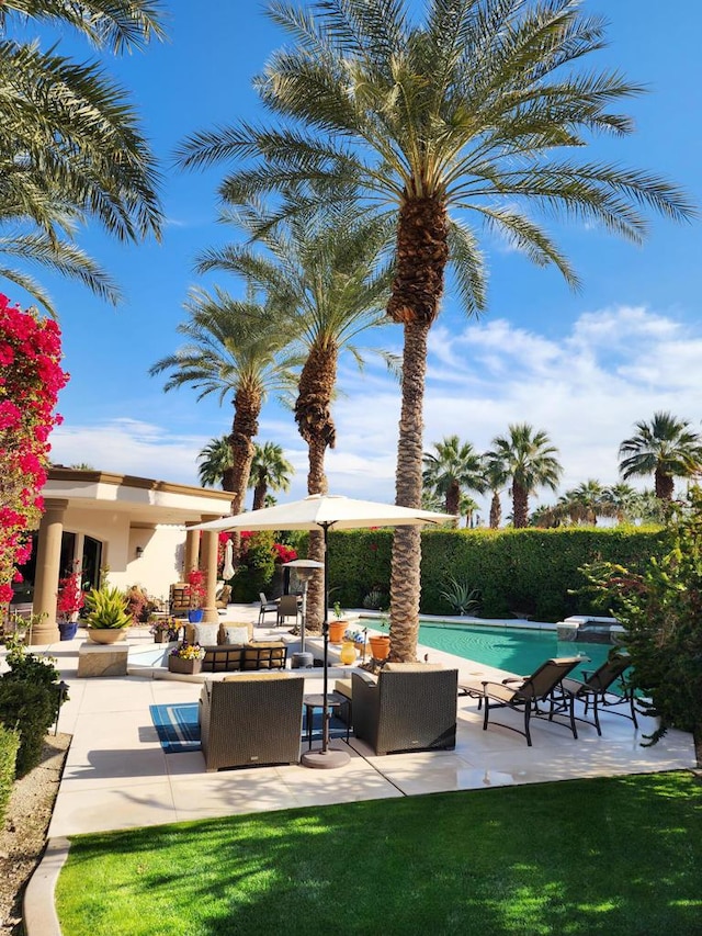 view of pool featuring an outdoor living space and a patio area