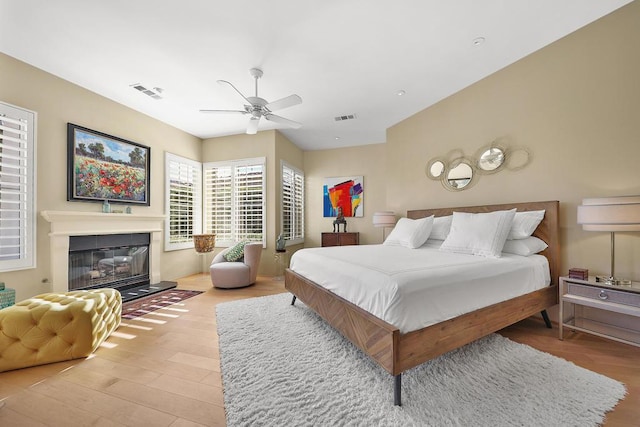 bedroom with ceiling fan and light hardwood / wood-style floors