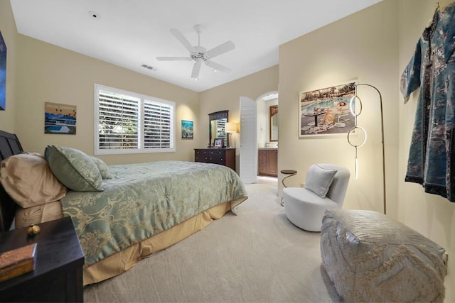 bedroom with connected bathroom, ceiling fan, and carpet