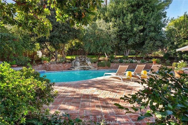 view of swimming pool featuring a patio area