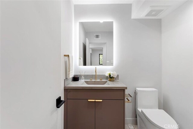 bathroom with toilet and vanity