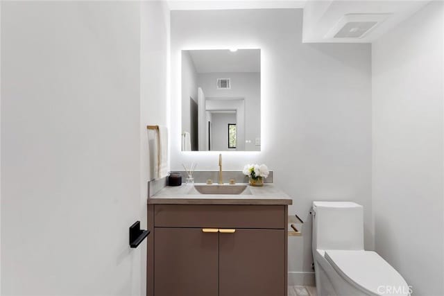 bathroom with vanity and toilet