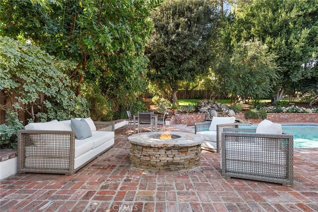 view of patio featuring an outdoor living space with a fire pit