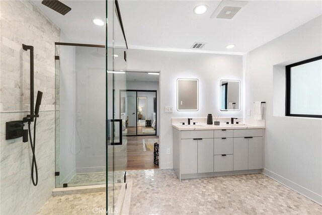 bathroom featuring walk in shower and vanity