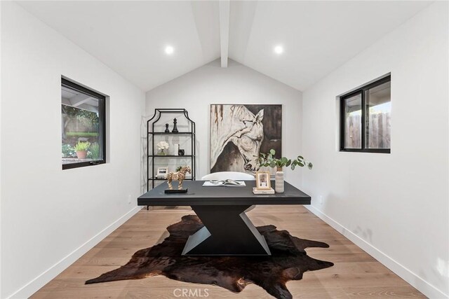 office area with hardwood / wood-style floors and lofted ceiling with beams