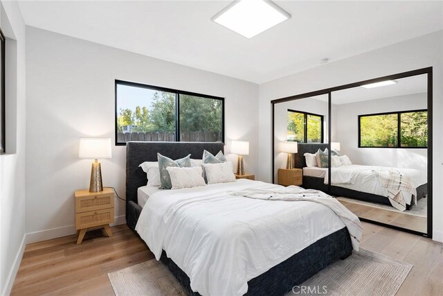 bedroom featuring light hardwood / wood-style floors and a closet