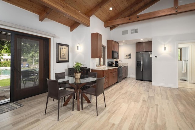 dining space featuring light hardwood / wood-style floors, wood ceiling, high vaulted ceiling, beam ceiling, and sink