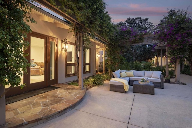 patio terrace at dusk featuring outdoor lounge area