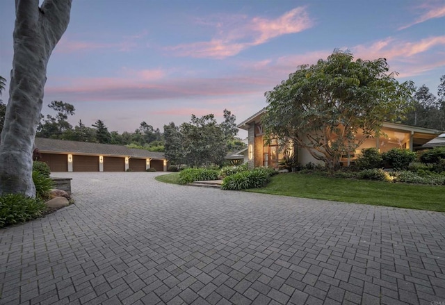 view of front of house featuring a yard and a garage