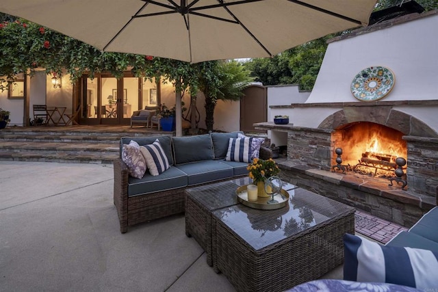 view of patio with area for grilling and an outdoor living space with a fireplace