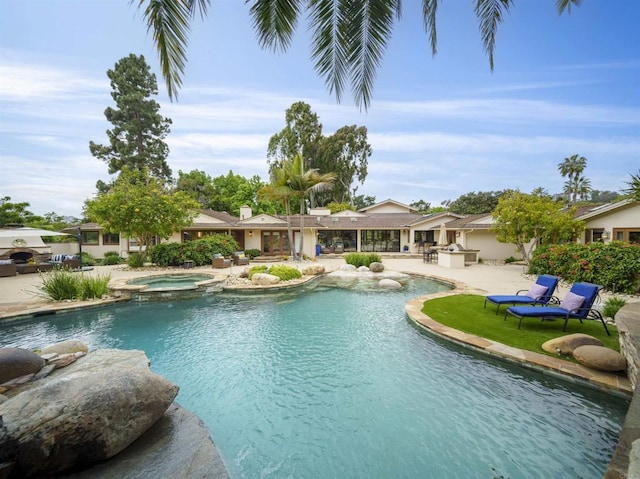 view of swimming pool with a patio and an in ground hot tub