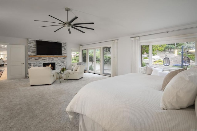 carpeted bedroom featuring ceiling fan, a stone fireplace, french doors, and access to outside