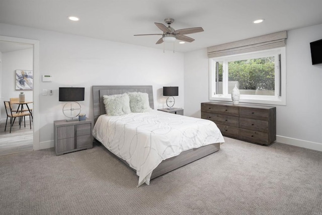 bedroom with ceiling fan and light colored carpet