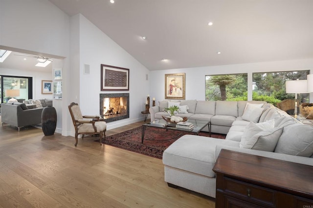 5041 El Secreto, Rancho Santa Fe, CA 92067 - living room featuring a lit fireplace, high vaulted ceiling, light wood-type flooring, baseboards, and recessed lighting