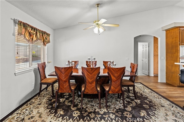 dining space featuring ceiling fan, hardwood / wood-style flooring, and lofted ceiling