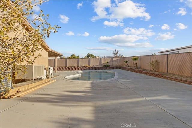 view of pool featuring a patio and central AC