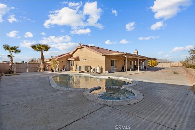 view of pool featuring a patio area and an in ground hot tub