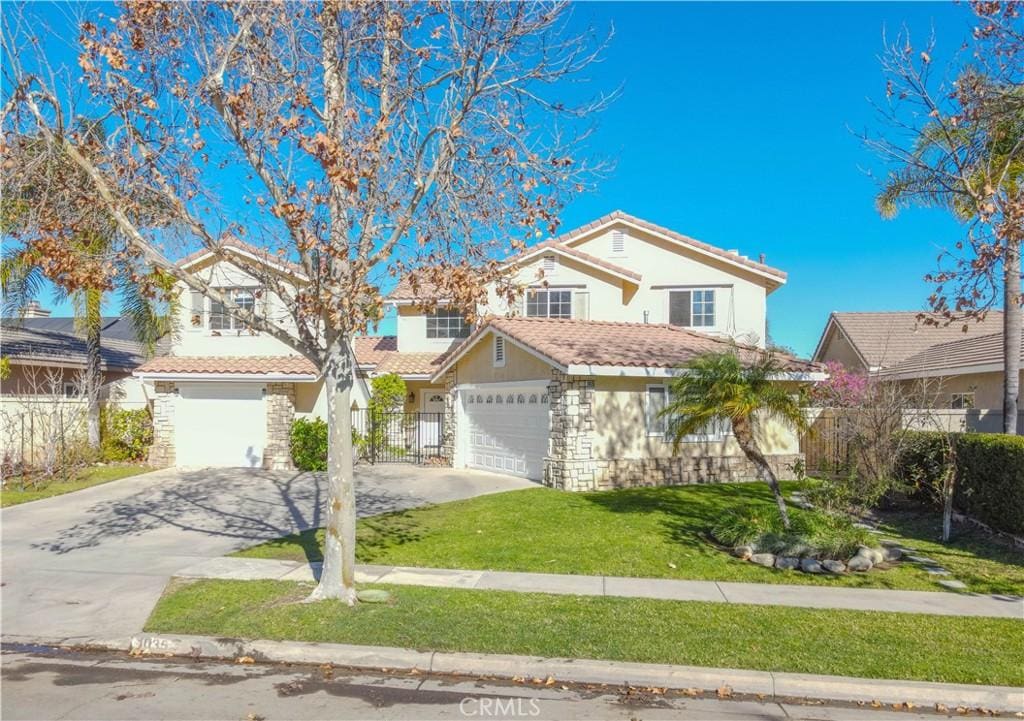 front of property with a front yard and a garage