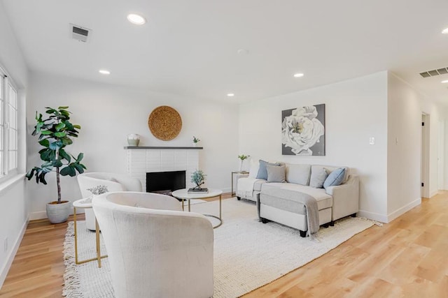 living room with a fireplace and hardwood / wood-style flooring