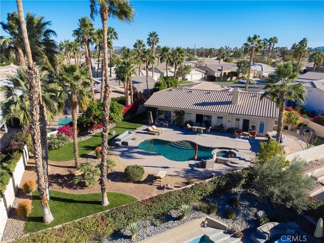 view of swimming pool with a patio area and an in ground hot tub