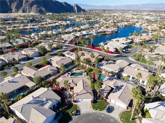 drone / aerial view with a water and mountain view