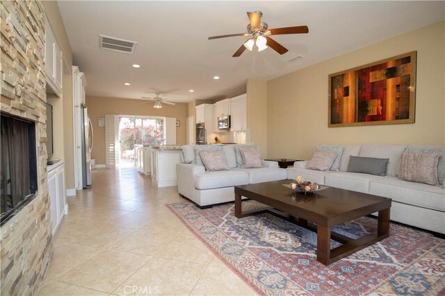 living room featuring ceiling fan and light tile patterned floors