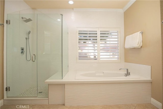 bathroom with tile patterned flooring, crown molding, and plus walk in shower