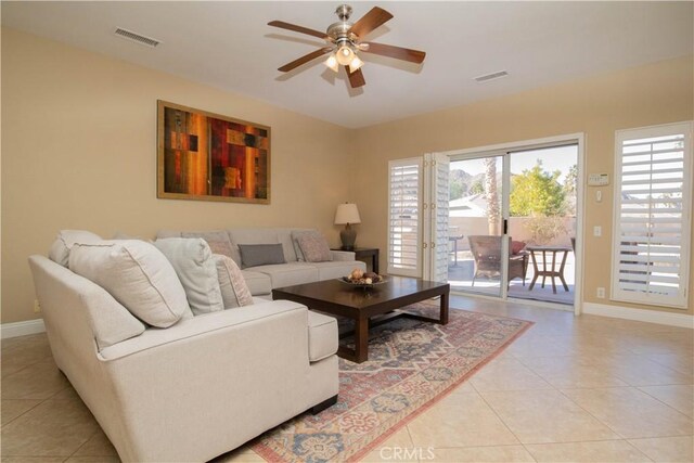 living room with ceiling fan and light tile patterned flooring