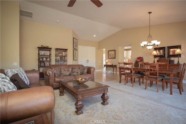 living room featuring ceiling fan with notable chandelier and lofted ceiling