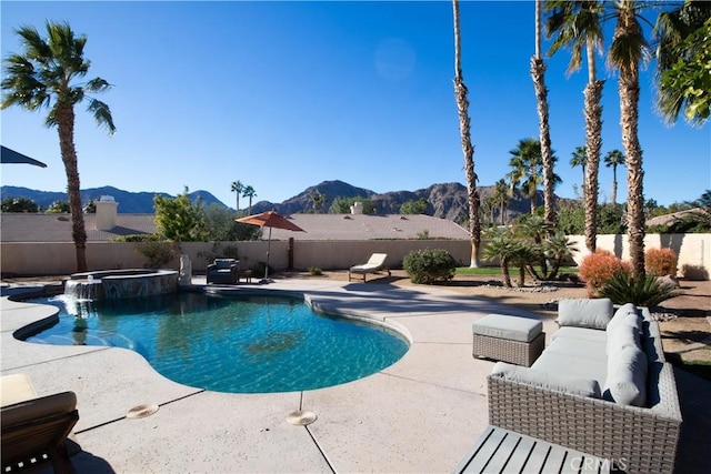 view of swimming pool featuring a mountain view, an in ground hot tub, and a patio