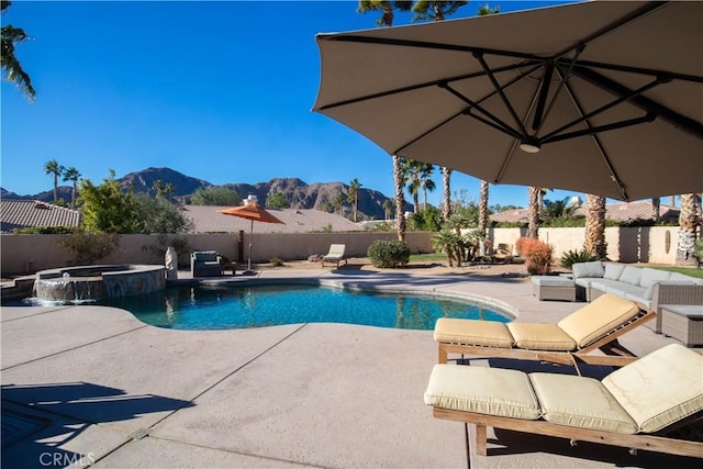 view of swimming pool featuring a mountain view, an in ground hot tub, and a patio