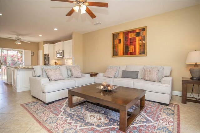 living room featuring ceiling fan and light tile patterned floors