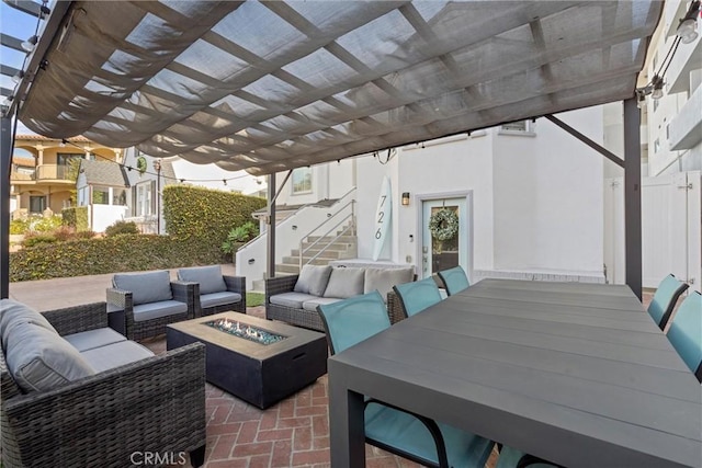 view of patio featuring an outdoor living space with a fire pit and a pergola