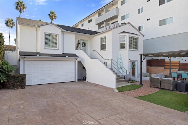 view of front of house featuring a garage and outdoor lounge area