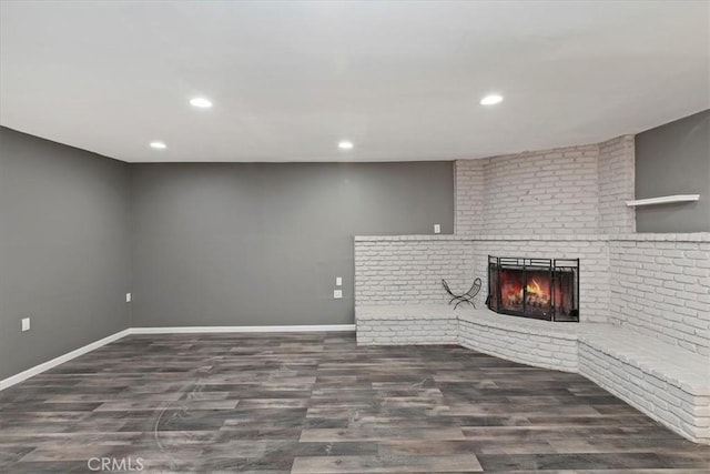 unfurnished living room featuring dark hardwood / wood-style flooring and a fireplace