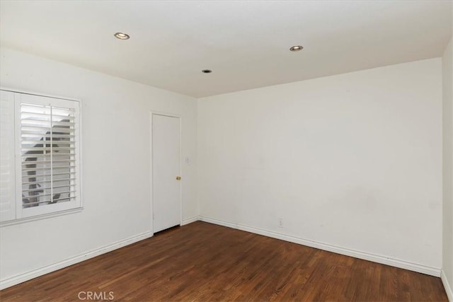 empty room featuring dark wood-type flooring