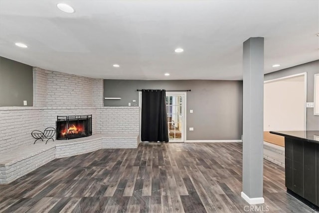 unfurnished living room featuring dark hardwood / wood-style flooring and a fireplace