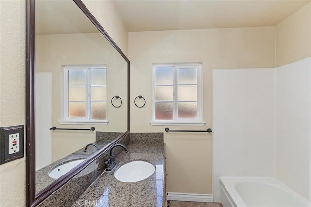 bathroom featuring vanity and a bathing tub